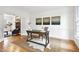 A bright home office with hardwood floors and white walls, showcasing a rustic desk at 102 Legault Dr, Cary, NC 27513