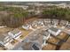 Aerial of homes within a community; highlighting various exterior styles and lush surrounding trees at 1026 Janiskee Rd, Durham, NC 27703