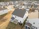 Aerial view of a backyard and sunroom addition on a white two-story house in a neighborhood at 1026 Janiskee Rd, Durham, NC 27703