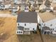 Aerial view of the backyard and a sunroom addition on a white two-story house at 1026 Janiskee Rd, Durham, NC 27703