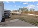 View of the backyard, featuring an expansive lawn area, a patio, and a black metal fence at 1026 Janiskee Rd, Durham, NC 27703