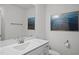 Bathroom with white vanity, framed mirror, ocean print and toilet at 1026 Janiskee Rd, Durham, NC 27703