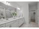 Elegant bathroom boasts a double sink vanity, large mirror, and updated fixtures at 1026 Janiskee Rd, Durham, NC 27703