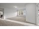 Spacious, carpeted bedroom with three windows, offering plenty of natural light at 1026 Janiskee Rd, Durham, NC 27703