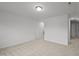 Large carpeted bedroom with neutral walls and ceiling light at 1026 Janiskee Rd, Durham, NC 27703