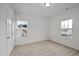 Cozy bedroom with two windows providing natural light and neutral carpet at 1026 Janiskee Rd, Durham, NC 27703