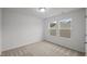 This bedroom has carpet flooring and natural light from 2 windows at 1026 Janiskee Rd, Durham, NC 27703