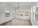 Sun-drenched dining area boasting beautiful light fixture and view of the exterior at 1026 Janiskee Rd, Durham, NC 27703