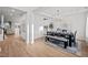 Open-concept dining room with elegant lighting fixture, hardwood floors, and a decorative painting on the wall at 1026 Janiskee Rd, Durham, NC 27703