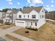 Charming home with a garage, light blue front door, and manicured landscaping at 1026 Janiskee Rd, Durham, NC 27703