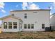 View of the home's side featuring an enclosed sunroom with lots of windows at 1026 Janiskee Rd, Durham, NC 27703