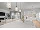 Bright kitchen with modern pendant lighting, stainless steel faucet, white marble counters and an open floor plan to living room at 1026 Janiskee Rd, Durham, NC 27703