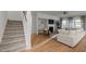 Spacious living room featuring a fireplace, adjacent staircase, modern decor, and hardwood floors at 1026 Janiskee Rd, Durham, NC 27703