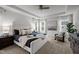 Spacious primary suite featuring an elegant tray ceiling, cozy chair and bright bay windows at 1026 Janiskee Rd, Durham, NC 27703