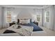 Inviting primary bedroom features a luxurious bed with plush bedding and bright windows at 1026 Janiskee Rd, Durham, NC 27703