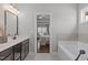 Open bathroom with soaking tub and view to the main bedroom at 1028 Allaire Dr, Raleigh, NC 27603