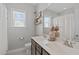 Bathroom featuring a double sink vanity, decorative shelves, and a large mirror at 1028 Allaire Dr, Raleigh, NC 27603