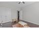 Bedroom showcasing dark wood flooring, closet space, and a doorway into another room at 1028 Allaire Dr, Raleigh, NC 27603
