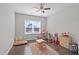 Bright bedroom features a ceiling fan, a window, and space for to play and learn at 1028 Allaire Dr, Raleigh, NC 27603