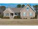 Charming single-Gathering home with brick and siding, featuring well-maintained landscaping and a welcoming entrance at 1028 Allaire Dr, Raleigh, NC 27603