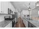 Bright kitchen features stainless appliances, granite countertops and white cabinets at 1028 Allaire Dr, Raleigh, NC 27603