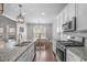 Well-appointed kitchen with stainless steel appliances, granite countertops, and an island with seating, adjacent to the dining area at 1028 Allaire Dr, Raleigh, NC 27603