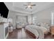 Spacious main bedroom with tray ceiling, ceiling fan and lots of natural light at 1028 Allaire Dr, Raleigh, NC 27603