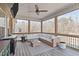 Outdoor patio featuring comfortable seating, a ceiling fan, and a view of the trees at 1028 Allaire Dr, Raleigh, NC 27603