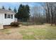 Spacious backyard featuring a fenced garden and mature trees, offering ample outdoor space at 104 E Laramie Dr, Mebane, NC 27302