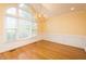 Elegant dining room with gleaming hardwood floors, large windows, and a decorative chandelier at 104 E Laramie Dr, Mebane, NC 27302