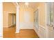 Entryway with hardwood floors, decorative columns, and natural light streaming through the windows at 104 E Laramie Dr, Mebane, NC 27302