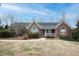 Charming one-story brick home featuring a cozy front porch and well-maintained landscaping at 104 E Laramie Dr, Mebane, NC 27302