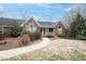 Inviting brick home featuring arched windows, a covered porch, and a well-manicured front yard at 104 E Laramie Dr, Mebane, NC 27302