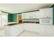 Functional kitchen with white cabinetry, black countertops, and stainless steel appliances at 104 E Laramie Dr, Mebane, NC 27302