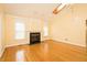 Spacious living room with hardwood floors, a fireplace, and natural light at 104 E Laramie Dr, Mebane, NC 27302