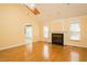Bright living room featuring hardwood floors, a fireplace, and large windows at 104 E Laramie Dr, Mebane, NC 27302
