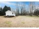 Backyard shed in a large grassy backyard with mature trees at 104 E Laramie Dr, Mebane, NC 27302