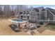Expansive property showcases a beautiful home, swimming pool, patio, waterfall feature, and meticulously landscaped grounds at 108 Springfield Pl, Hillsborough, NC 27278