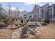 Stunning backyard featuring a stone patio with seating, cascading waterfall, lush landscaping, and a view of the house at 108 Springfield Pl, Hillsborough, NC 27278