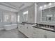 Bright bathroom with double vanity, soaking tub, and sleek fixtures offering a spa-like experience at 108 Springfield Pl, Hillsborough, NC 27278