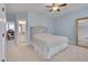 Charming bedroom featuring soft blue walls, a ceiling fan, and stylish headboard with a starfish decoration at 108 Springfield Pl, Hillsborough, NC 27278