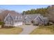 Beautiful gray home featuring a three-car garage and a well-manicured front yard at 108 Springfield Pl, Hillsborough, NC 27278
