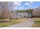 Stunning two-story home with a long driveway and lush front lawn on a sunny day at 108 Springfield Pl, Hillsborough, NC 27278
