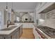 Open-concept kitchen features stone counters, tiled backsplash, and a gas range at 108 Springfield Pl, Hillsborough, NC 27278