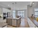 Bright kitchen featuring stainless appliances, a central island and white cabinetry at 108 Springfield Pl, Hillsborough, NC 27278
