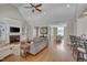Inviting living room with hardwood floors, fireplace, and open access to the dining area at 108 Springfield Pl, Hillsborough, NC 27278