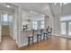Open-concept living area with a breakfast bar and hardwood floors, blending style and functionality at 108 Springfield Pl, Hillsborough, NC 27278