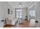 Cozy seating area featuring white sofa, hardwood floors, and french doors to the exterior at 108 Springfield Pl, Hillsborough, NC 27278