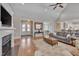Open-concept living room with hardwood floors, fireplace, and access to the kitchen at 108 Springfield Pl, Hillsborough, NC 27278
