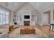 Charming living room featuring a fireplace, built-in shelving and hardwood floors at 108 Springfield Pl, Hillsborough, NC 27278